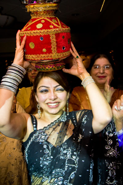 women carrying jug lanterns announce the forthcoming Sikh wedding