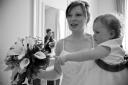 Baby Ella reaches for the wedding bouquet