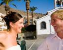 Bride and groom by chapel in Los Gigantes in Tenerife