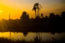 sunset along river by train tracks in Egypt