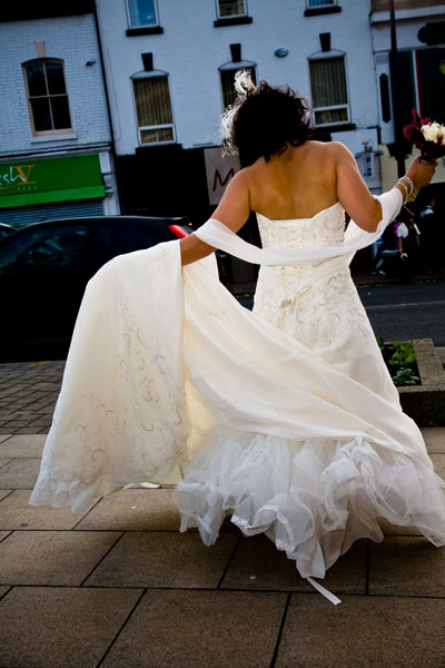 bride gives a twirl as arrives at Sale Register Office