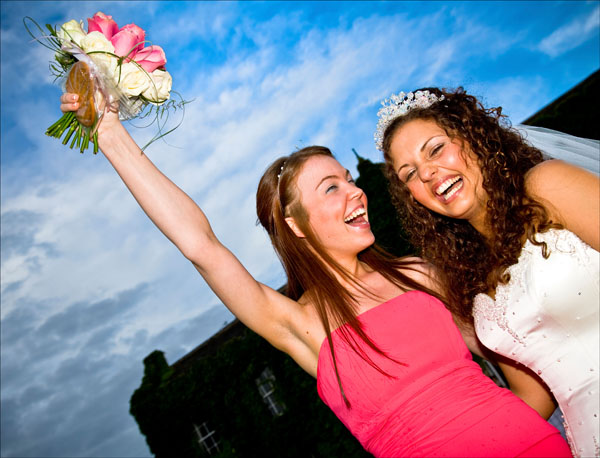 bridesmaid jubilantly catches the bouquet