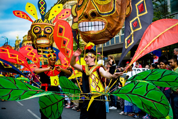 creative giant masks carried aloft by male Caribbean dancers in Huddersfield Carnival procession 2009