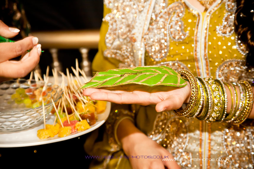 Henna is squeezed onto a leaf on the bride's hand