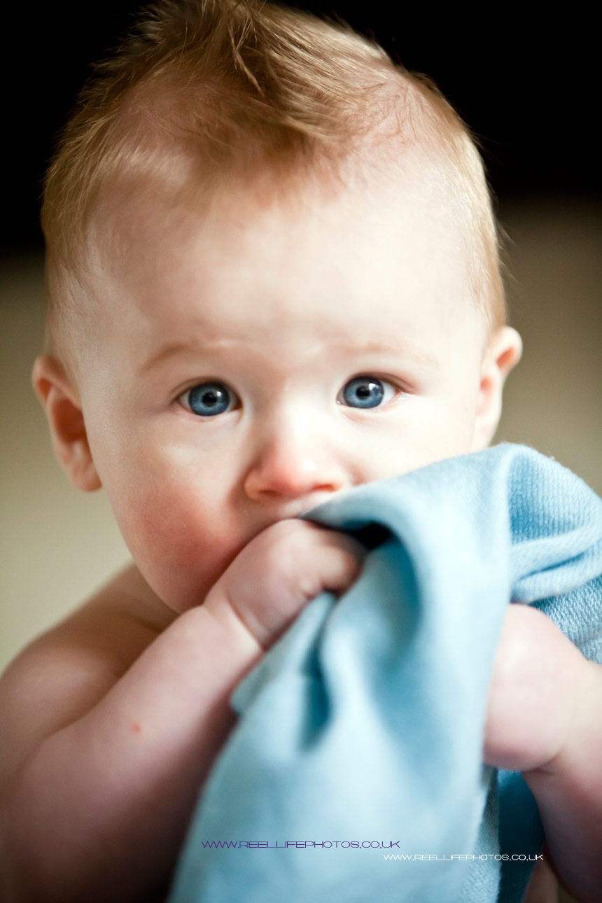 baby with blue blanket