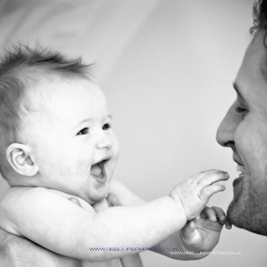 baby playing with his Dad