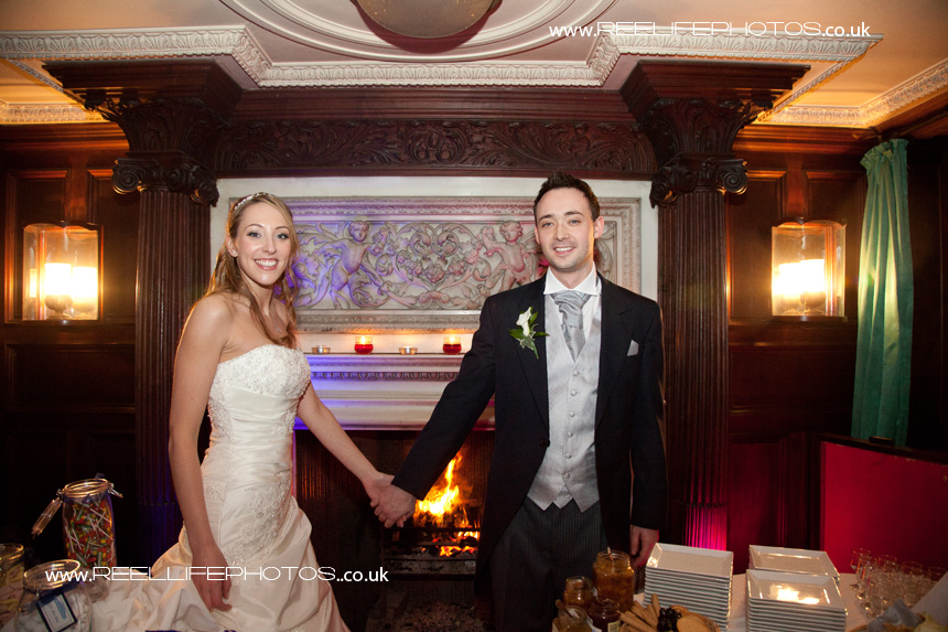 bride and groom by the fireplace at Thornton Manor