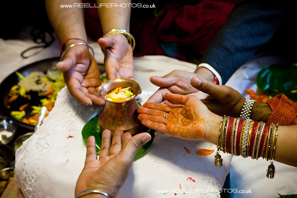 Hindu wedding Sainth prayer ceremony hands