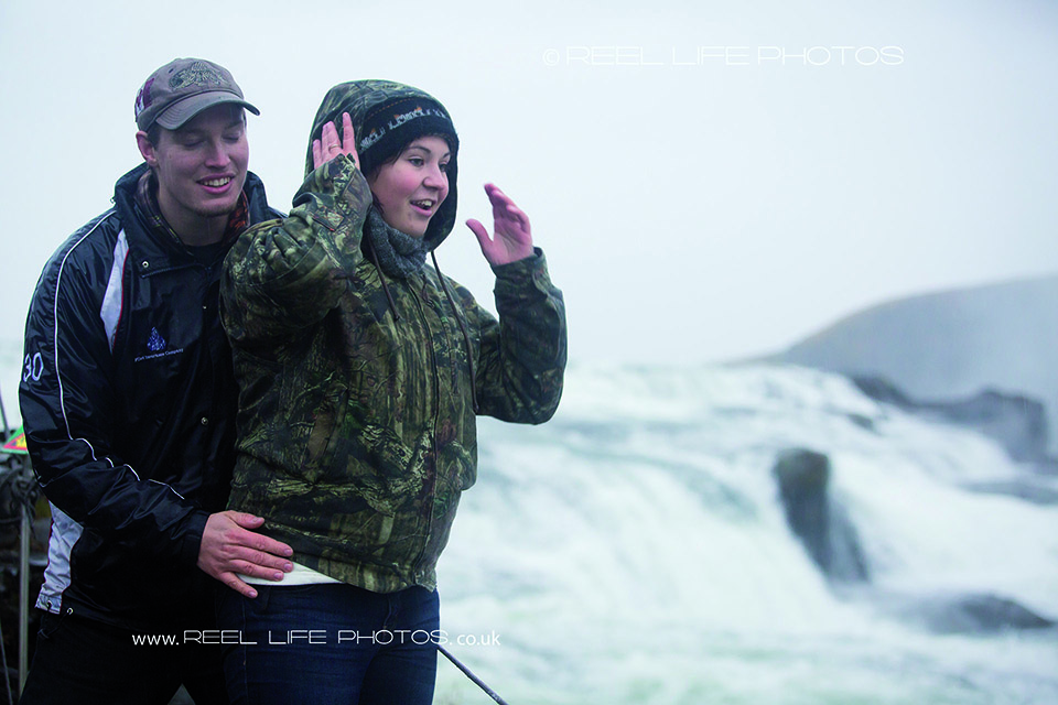 Reprtage rather than posed engagement photos in Iceland on a rainy October day at Selfoss waterfall.