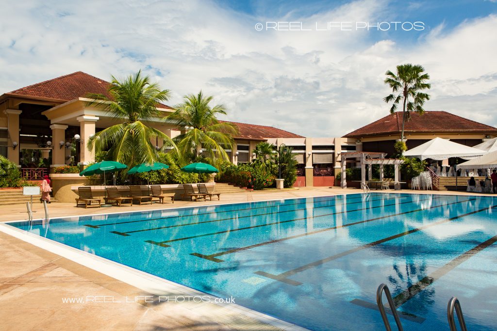 View over the pool at Kelab Bandar Laguna Merbok towrds the wedding venue during a Malaysian wedding