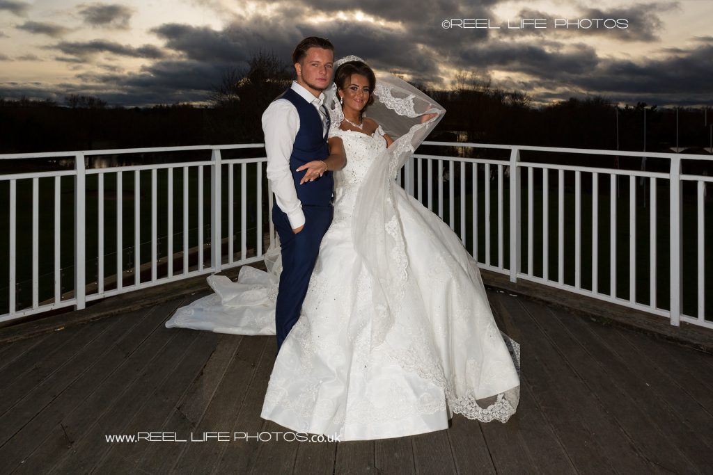 gypsy wedding pic with the big dress against a dramatic dark sky during the evening wedding reception